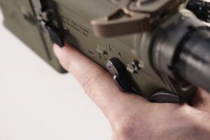 A hand holding an AR 15 with an ambidextrous safety selector