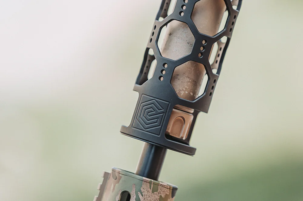 Close-up of a camo-patterned rifle, showcasing intricate details of the design and texture.